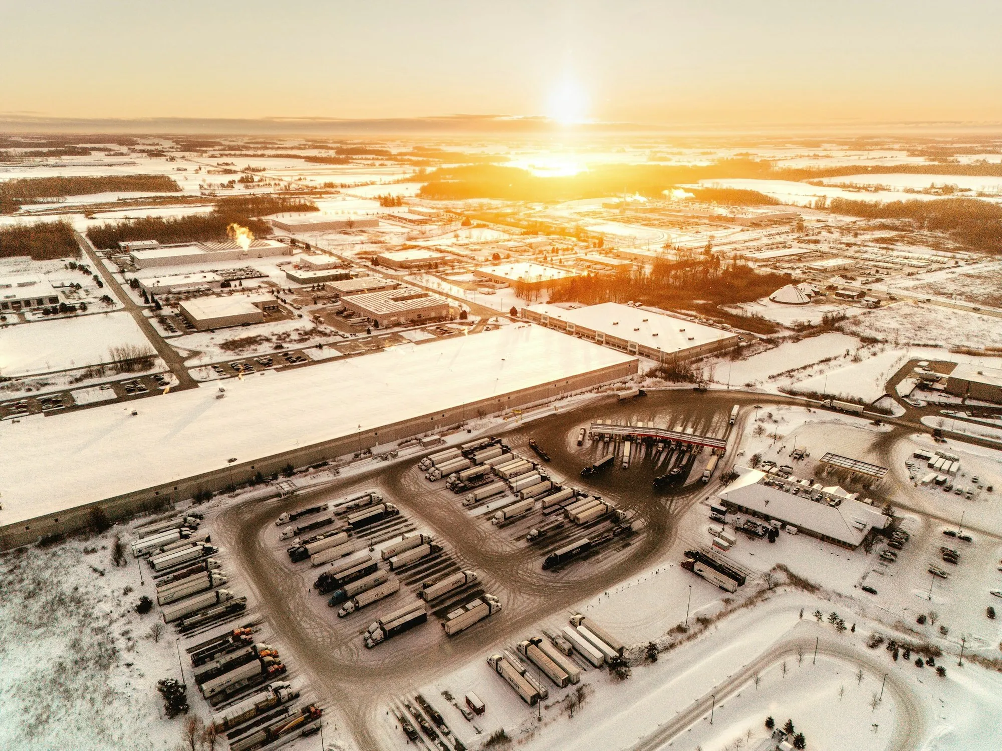 Aerial view of a distribution park in snow at sunrise