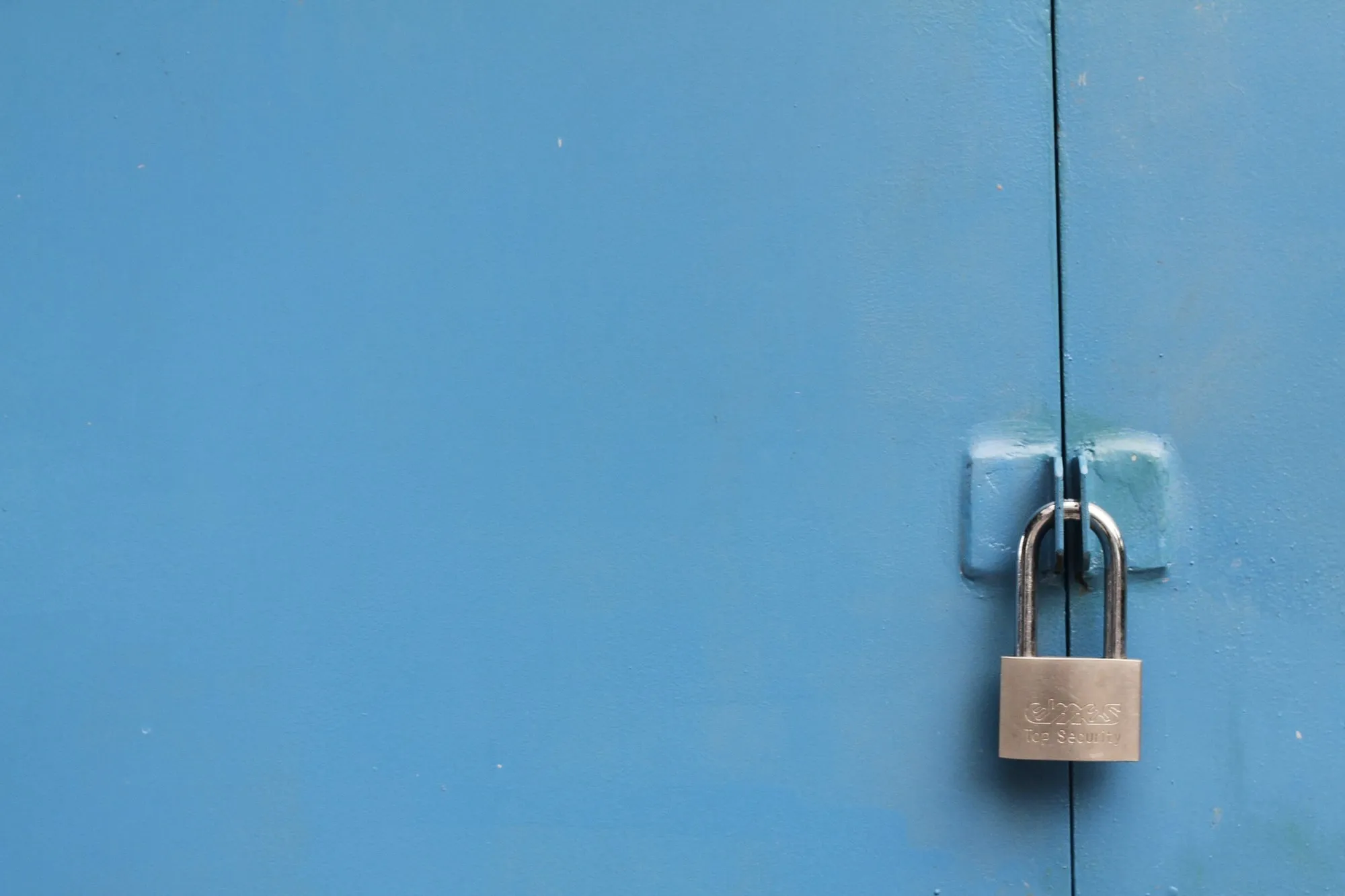 A padlock on a steel door