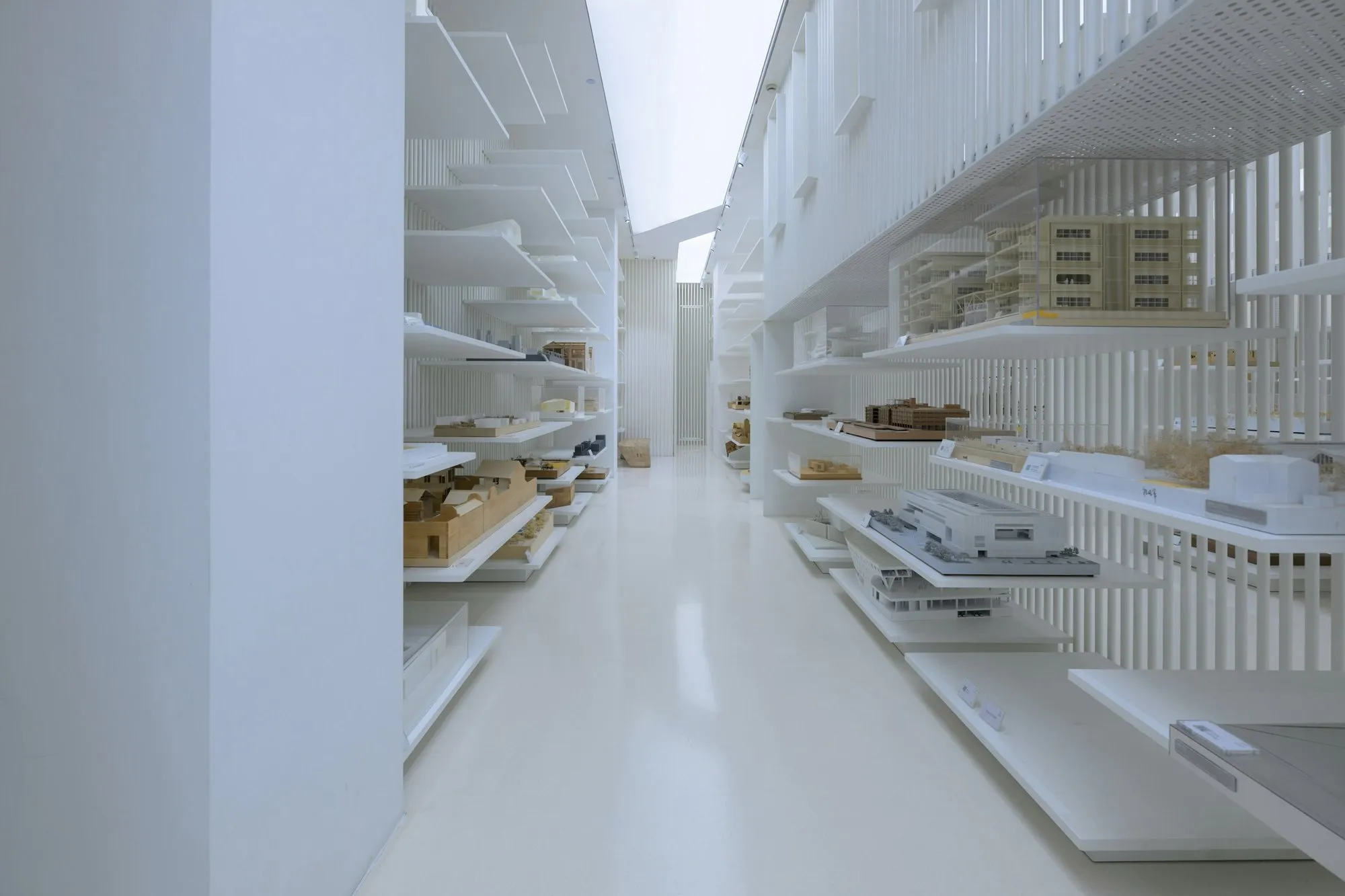 A long white shelving aisle in a clean storage area